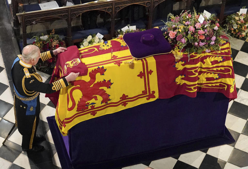 King Charles III places the Queen’s Company Camp Colour of the Grenadier Guards on the coffin at the Committal Service for Queen Elizabeth II, held at St George’s Chapel in Windsor Castle, Monday Sept. 19, 2022. (Jonathan Brady/Pool Photo via AP)