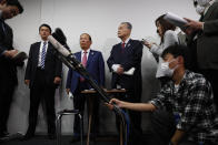The Tokyo 2020 Organizing Committee's Toshiro Muto, center left, and Yoshiro Mori, center right, listen to questions from the media during a news conference in Tokyo, Wednesday, March 4, 2020. The Olympic Games are under threat from a spreading virus from China that has reached the pandemic stage. (AP Photo/Jae C. Hong)