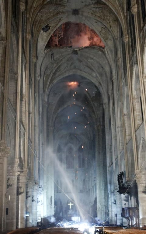 General view of the interior of the Notre-Dame Cathedral as flames burn the roof - Credit: Rex