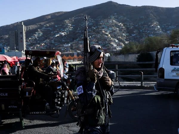 A Taliban fighter stands on a street in Kabul. (Photo Credit - Reuters)