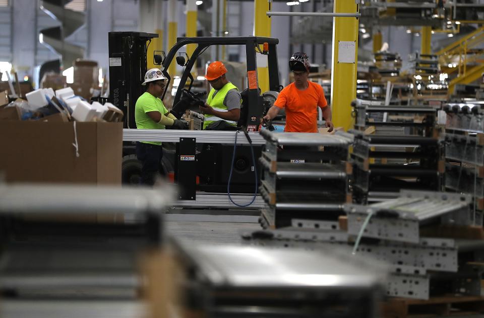 Workers view a conveyor belt system that is under construction at a new Amazon fulfillment center on August 10, 2017 in Sacramento, California. (Photo by Justin Sullivan/Getty Images)