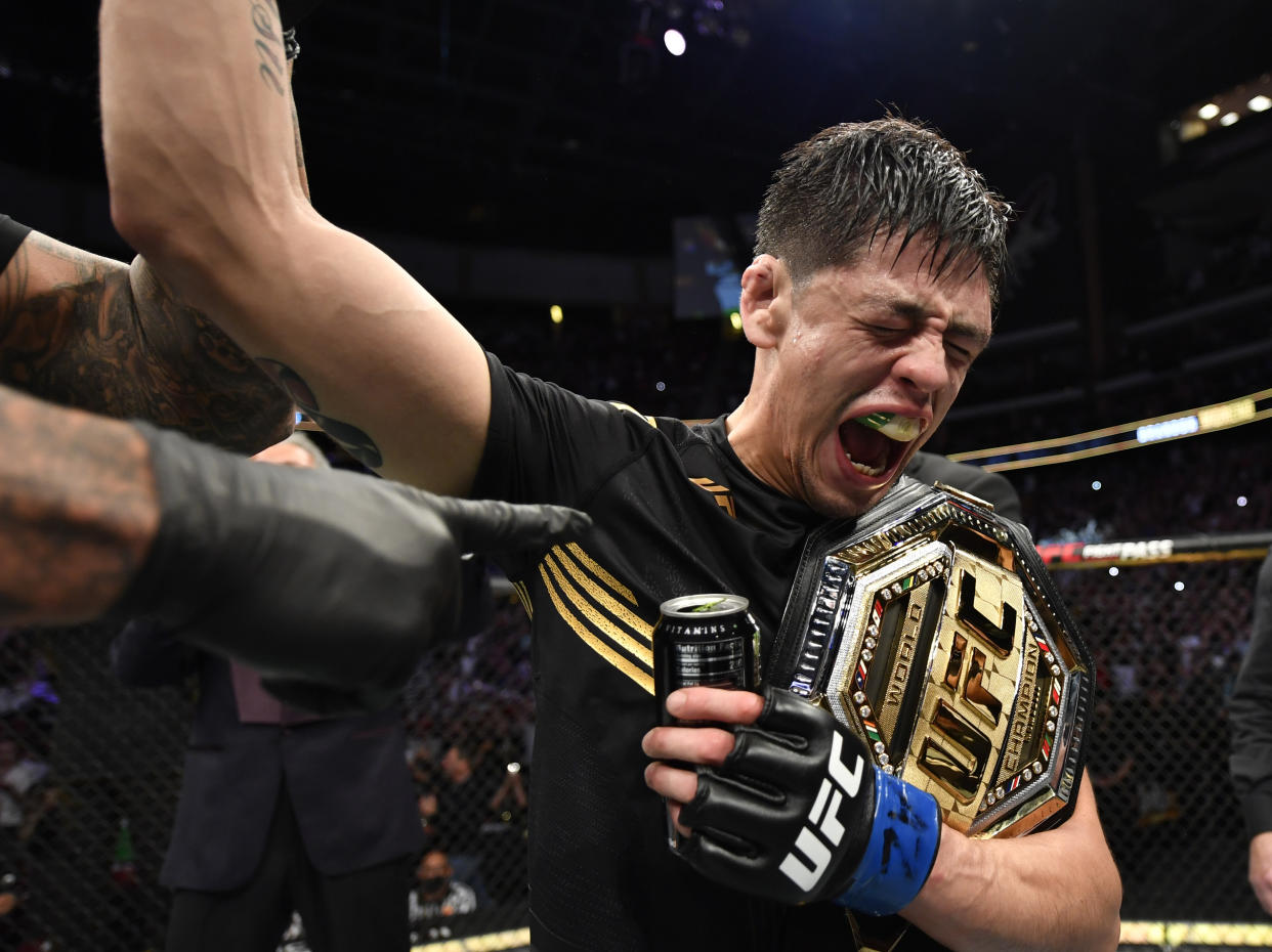 GLENDALE, ARIZONA - JUNE 12: Brandon Moreno of Mexico reacts after submitting Deiveson Figueiredo of Brazil to win the UFC flyweight championship fight during the UFC 263 event at Gila River Arena on June 12, 2021 in Glendale, Arizona. (Photo by Jeff Bottari/Zuffa LLC)