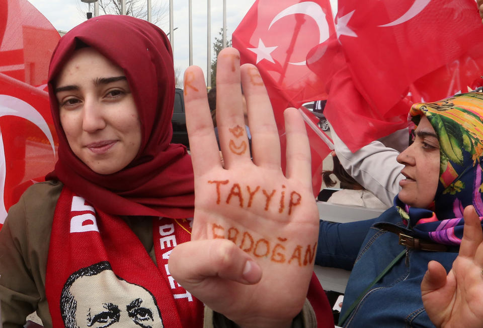 A woman shows her hand, which reads “Tayyip Erdogan”