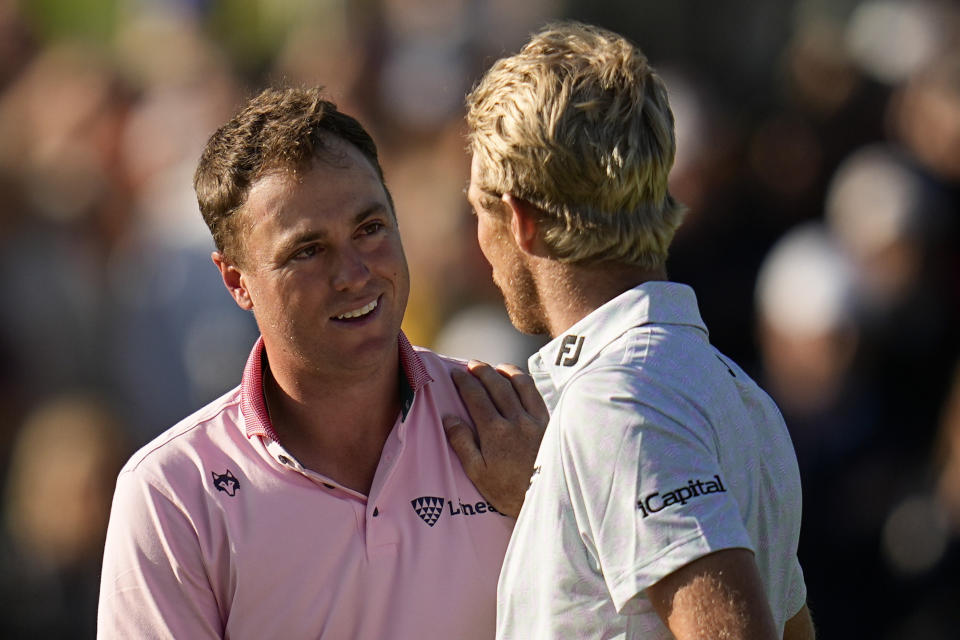 Justin Thomas, left, is greeted by Will Zalatoris after winning the PGA Championship golf tournament in a playoff at Southern Hills Country Club, Sunday, May 22, 2022, in Tulsa, Okla. (AP Photo/Sue Ogrocki)