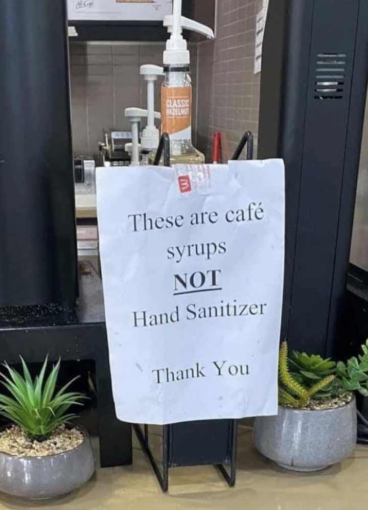 Sign says, These are cafe syrups not hand sanitizer