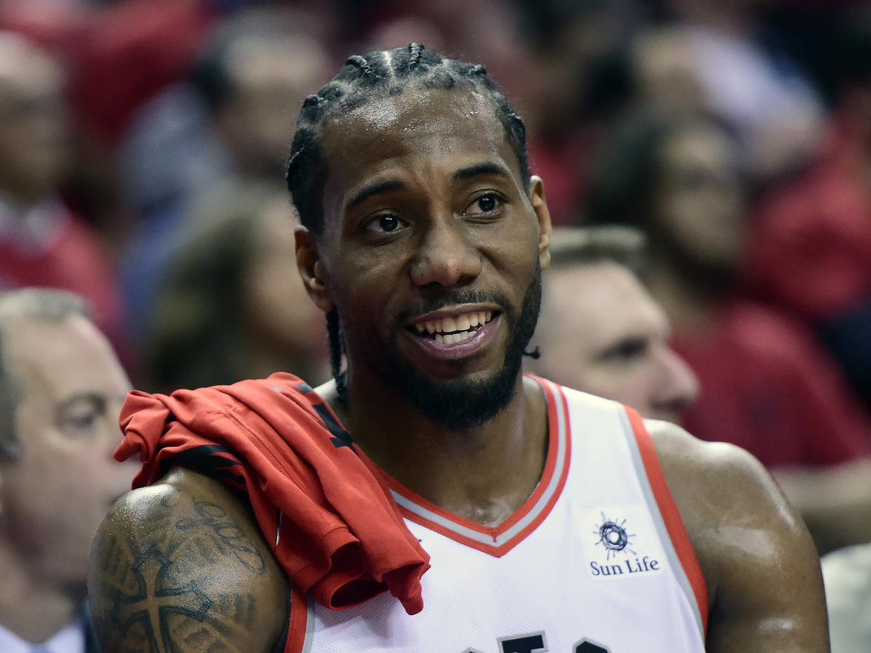 Toronto Raptors forward Kawhi Leonard (2) smiles from the bench during the second half of Game 4 of the NBA basketball playoffs Eastern Conference finals against the Milwaukee Bucks, Tuesday, May 21, 2019 in Toronto. (Frank Gunn/The Canadian Press via AP)