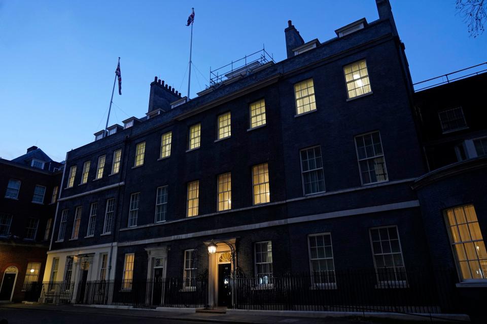A light shines above the door of 10 Downing Street, the official residence of Britain's Prime Minister, in central London on January 31, 2022. - British Prime Minister Boris Johnson on Monday apologised after his government was criticised for 