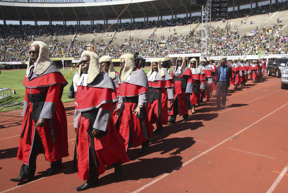 Judges arrive for the inauguration ceremony of Zimbabwean President Emmerson Mnangagwa, at the National Sports Stadium in Harare, Sunday, Aug. 26, 2018. (AP Photo/Wonder Mashura)
