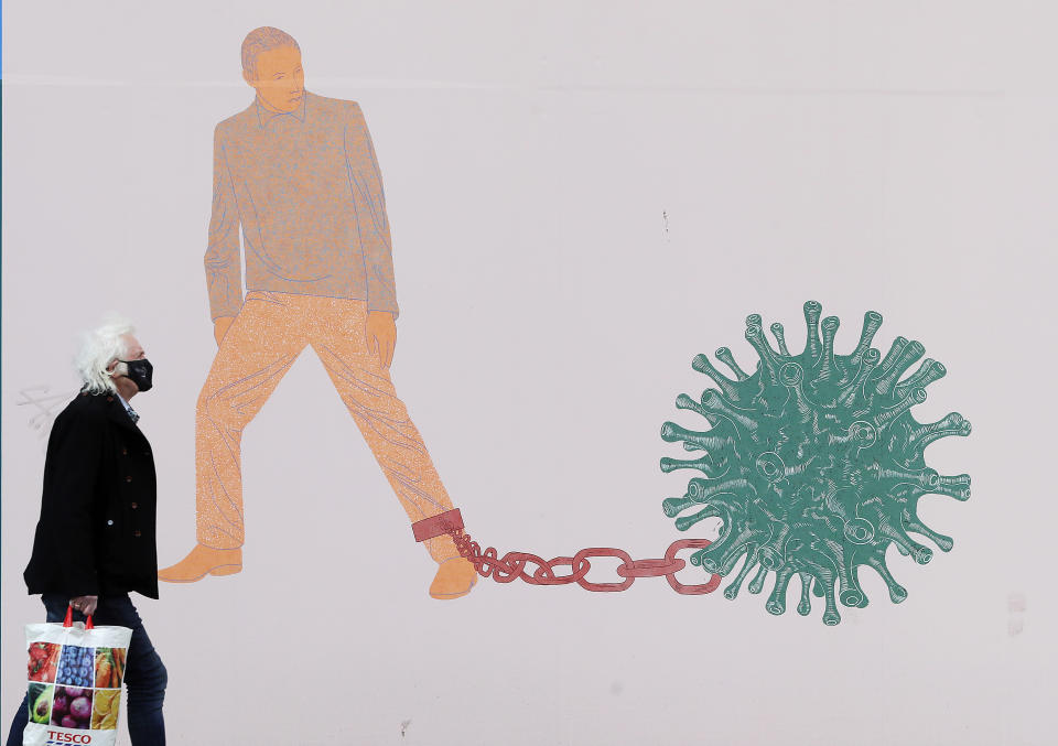 A man walks past part of the 'IN THESE STRANGE TIMES: an evolving series created in response to the pandemic' exhibition at the Science Gallery in Dublin's city centre. There have been four further deaths linked to Covid-19 and an additional 434 confirmed cases, the Department of Health has said. Dr. Holohan has called for caution as the country continues to open up. Picture date: Friday May 7, 2021. See PA story IRISH Coronavirus.