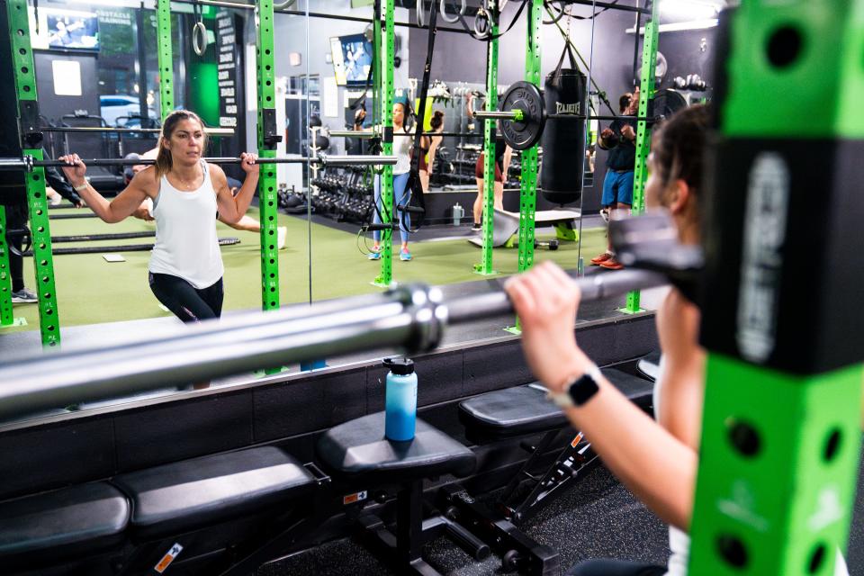 Daisy Andonyadis, a third grade teacher at Cora Kelly School, works out at E60 Fitness in Arlington, before work.