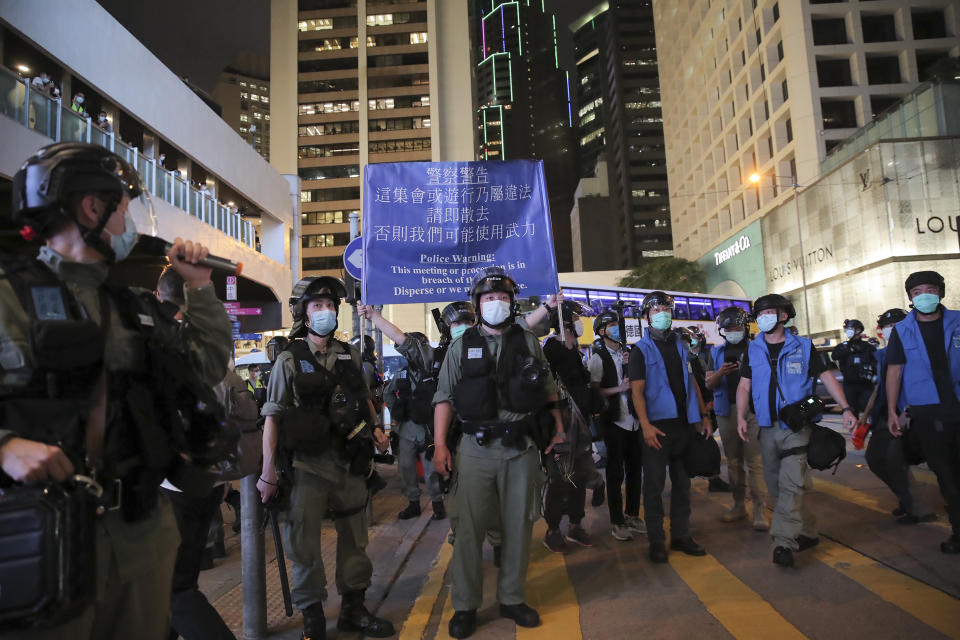 Police display a warning to disperse banner during a protest marking the first anniversary of a mass rally against the now-withdrawn extradition bill in Hong Kong, Tuesday, June 9, 2020. One year ago, a sea of humanity a million people by some estimates marched through central Hong Kong on a steamy afternoon. It was the start of what would grow into the longest-lasting and most violent anti-government movement the city has seen since its return to China in 1997. (AP Photo/Kin Cheung)