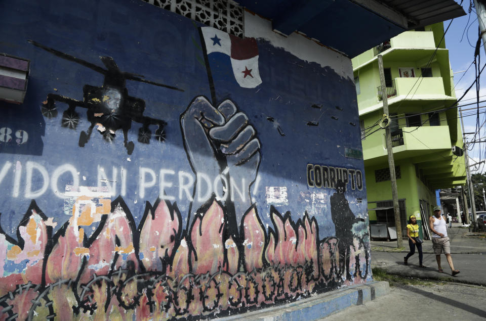 In this Dec. 15, 2019 photo, a mural depicting the U.S. invasion of Panama covers a wall in El Chorrillo, the neighborhood from which former Gen. Manuel A. Noriega lead his headquarters, and which was destroyed during the 1989 attack, in Panama City. The invasion began with fierce bombing in htis neighborhood, destroying wooden homes and displacing thousands of people. (AP Photo/Arnulfo Franco)