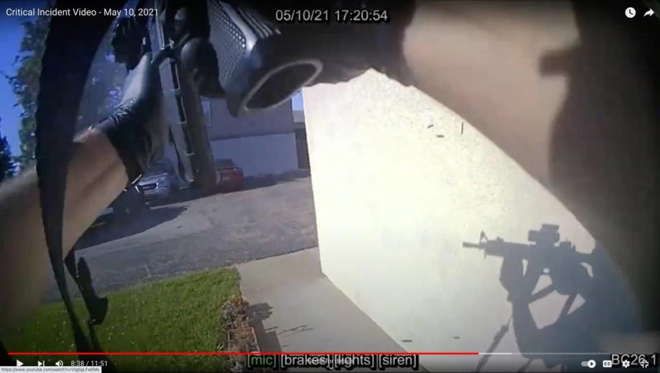 A screenshot from body camera video shows a San Luis Obispo police officer returning fire at Edward Giron after Giron shot and killed Det. Luca Benedetti during the serving of a search warrant at Giron’s Camellia Court apartment in San Luis Obispo on May 10, 2021.