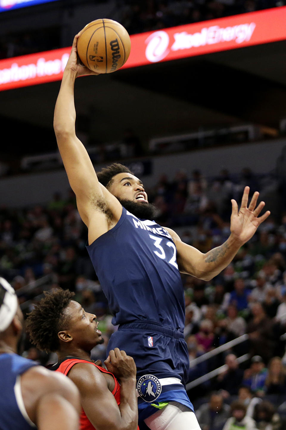 Minnesota Timberwolves center Karl-Anthony Towns (32) goes in for a dunk in front of Houston Rockets forward Jae'Sean Tate during the first half of an NBA basketball game Wednesday, Oct. 20, 2021, in Minneapolis. (AP Photo/Andy Clayton-King)