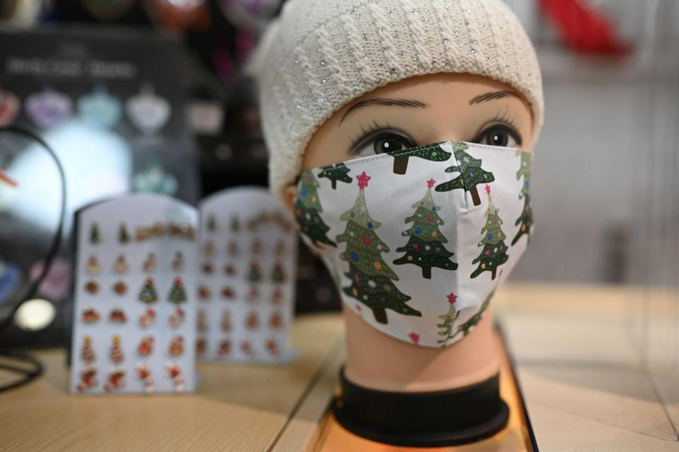 Face masks for sale during the novel coronavirus COVID-19 pandemic, are displayed at a shop in the centre of Warrington, north west England on December 1, 2020, as non essential retailers prepare to reopen following a second national lockdown to combat the spread of the novel coronavirus. - England will re-enter a tiered system of toughened regional restrictions to help contain the spread of COVID-19, when the current lockdown expires on December 2, bolstered by major testing programmes in areas with the highest rates. (Photo by Oli SCARFF / AFP) (Photo by OLI SCARFF/AFP via Getty Images)