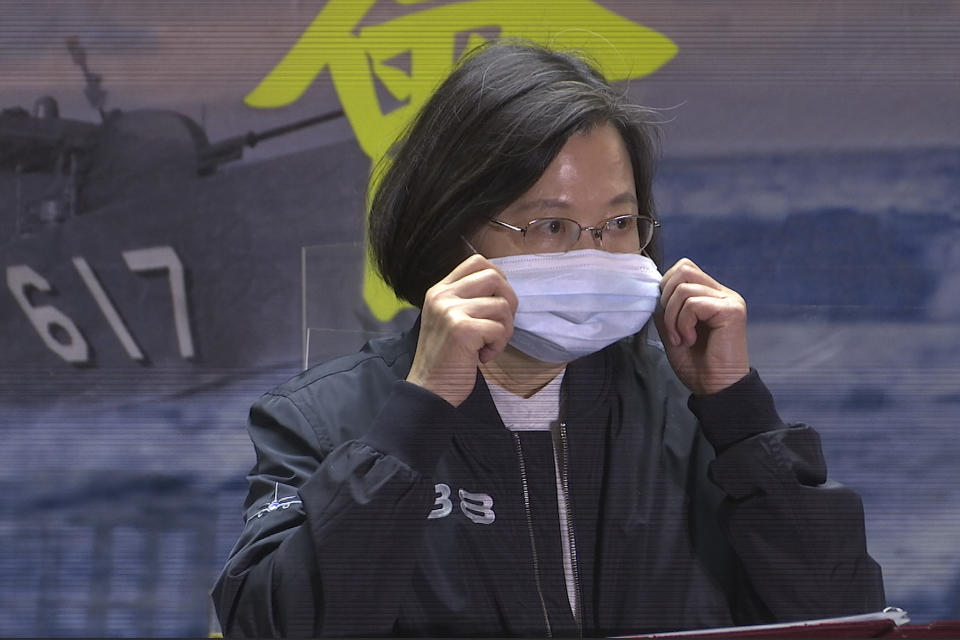 In this image from a video, Taiwanese President Tsai Ing-wen adjusts her face mask while delivering a speech to the servicemembers of the 131st Flotilla in the northern port of Keelung, Taiwan Monday, March 8, 2021. Tsai visited a naval base on Monday to thank sailors and marines for their dedication to protecting the island amid renewed threats from China, vowing not to allow the loss of “any single inch" of territory. (AP Photo/Johnson Lai)