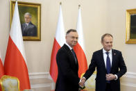 Poland's President Andrzej Duda, left, who is allied with the right-wing opposition, and new pro-European Union Prime Minister Donald Tusk shake hands before talks on Poland's security and continuing support for neighbouring Ukraine, at the Presidential Palace in Warsaw, Poland, Monday Jan. 15, 2024. Tusk is to travel to Kyiv in the coming days at the invitation of Ukraine President Volodymyr Zelenskyy. (AP Photo/Czarek Sokolowski)