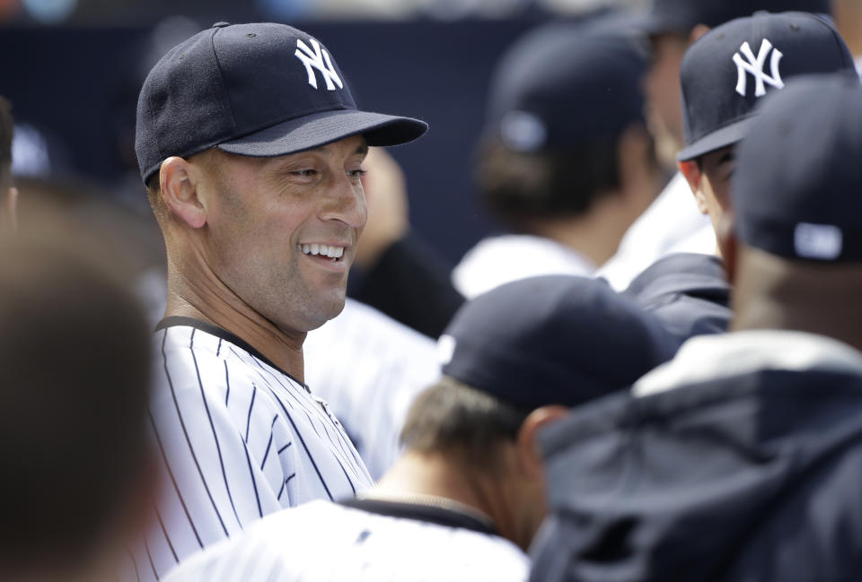 New York Yankees shortstop Derek Jeter laughs with teammates in the dugout during an exhibition baseball game against the Pittsburgh Pirates Thursday, Feb. 27, 2014, in Tampa, Fla. (AP Photo/Charlie Neibergall)