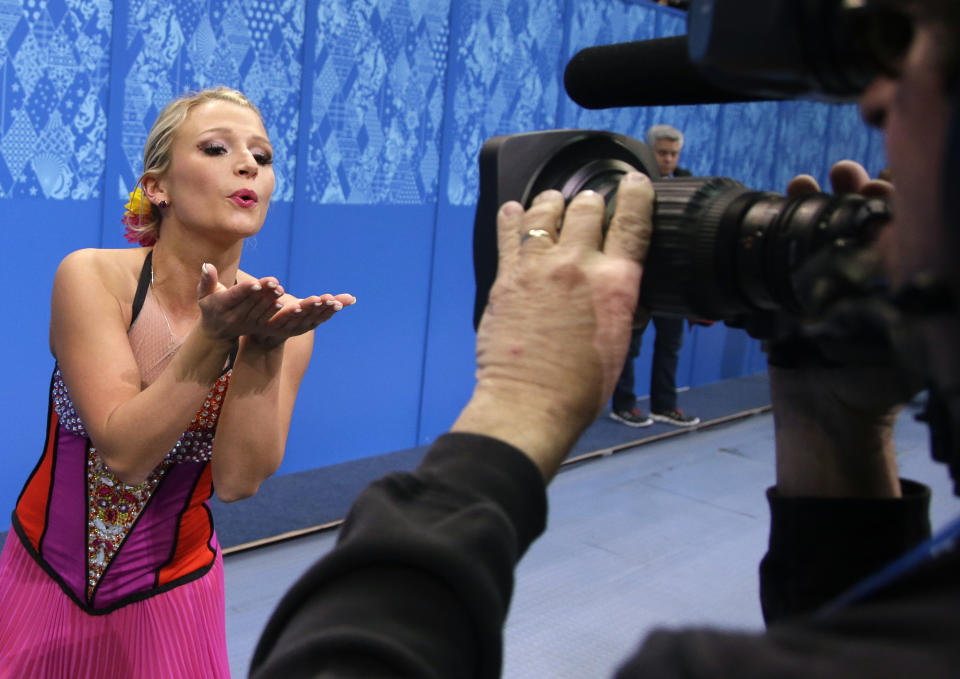 Kirsten Moore-Towers blows a kiss to a camera after she and Dylan Moscovitch of Canada competed in the pairs short program figure skating competition at the Iceberg Skating Palace during the 2014 Winter Olympics, Tuesday, Feb. 11, 2014, in Sochi, Russia. (AP Photo/Darron Cummings)