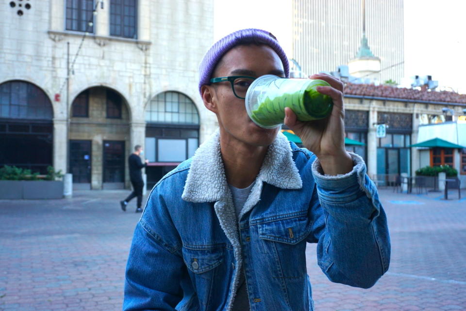 Author drinking the venti iced matcha green tea latte