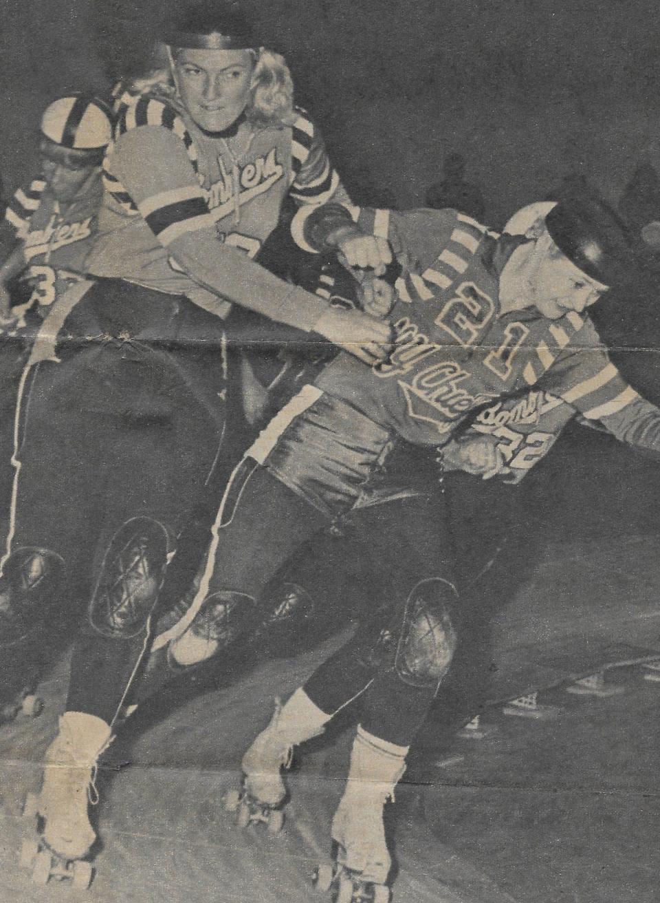 Elbows fly as New York Chiefs captain Joan Kazmerski attempts an inside pass on San Francisco Bay Bombers star Joan Weston in 1966. This clipping is from the Beacon Journal archives.