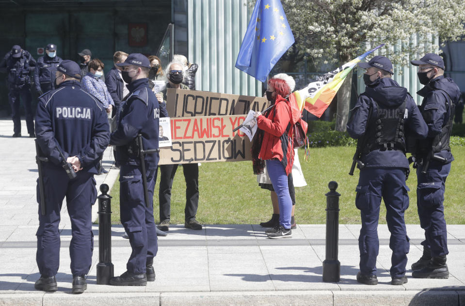 Protesters gather outside the Supreme Court in Warsaw, Poland, Thursday, May 6, 2021. Inside the Disciplinary Chamber of the court was examining the case of a judge. A top European Union legal advisor argued in an opinion Thursday that the chamber for disciplining judges is contrary to EU law.(AP Photo/Czarek Sokolowski)