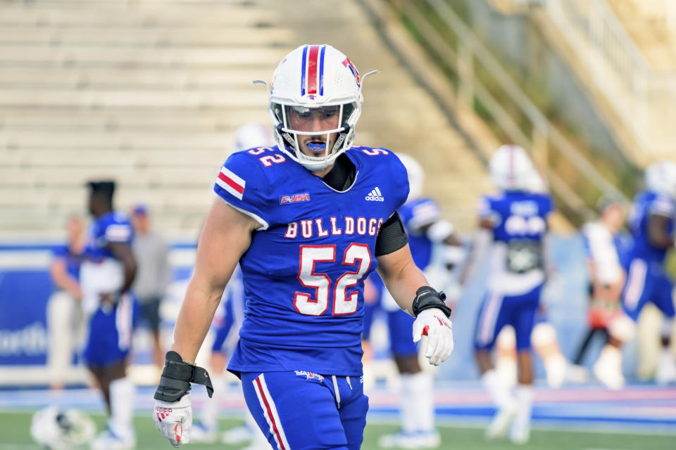 FILE - Louisiana Tech linebacker Tyler Grubbs (52) runs during an NCAA college football game against UTSA in Ruston, La., Saturday, Oct. 23, 2021. Here are six players going places in 2022, even if their teams aren’t: Arizona receiver Jacob Cowing, Louisiana Tech linebacker Tyler Grubbs, Kansas safety Kenny Logan Jr., Buffalo linebacker James Patterson, Northwestern offensive lineman Peter Skoronski and Syracuse running back Sean Tucker.(AP Photo/Matthew Hinton, File)