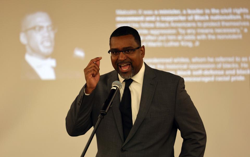 Rahsaan Hall portrays Malcolm X during a Brockton Area NAACP homage to influential Black leaders at the library on Saturday, Feb. 4, 2023.