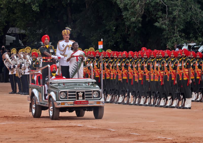 India's new President Droupadi Murmu inspects an honour guard in New Delhi