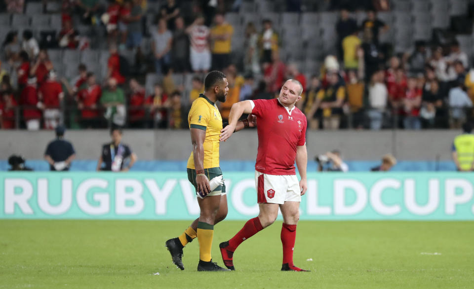 Wales Ken Owens, right, and Australia's Samu Kerevi leave the pitch after the Rugby World Cup Pool D game at Tokyo Stadium between Australia and Wales in Tokyo, Japan, Sunday, Sept. 29, 2019. Wales won the match 29-25. (AP Photo/Eugene Hoshiko)