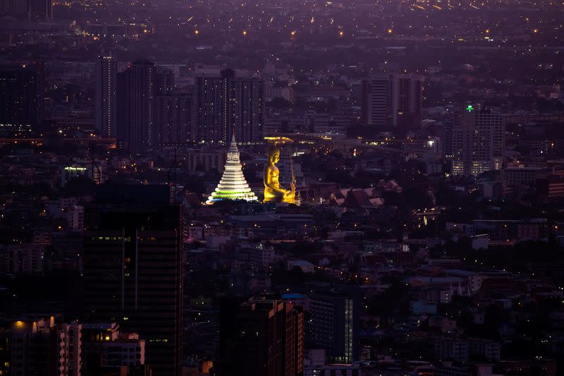 Giant Buddha statue of Wat Paknam Phasi Charoen temple is seen during sunset in Bangkok