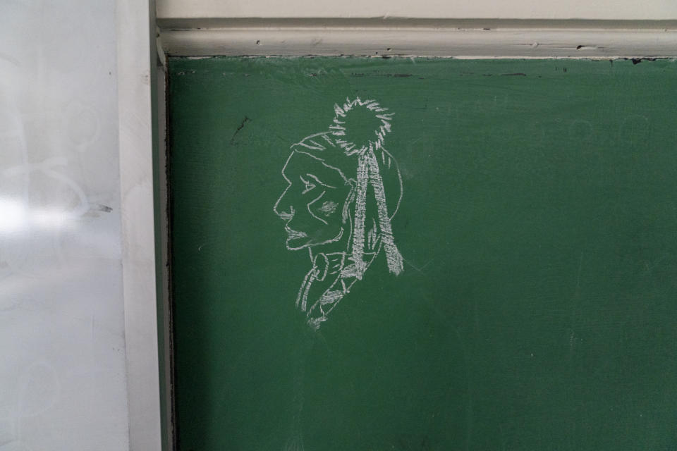 A drawing is displayed on a chalkboard in an abandoned classroom at Bacone College, on Jan. 8 2024, in Muskogee, Okla. Founded in 1880 as a Baptist missionary college focused on assimilation, Bacone College transformed into an Indigenous-led institution that provided an intertribal community, as well as a degree. (AP Photo/Nick Oxford)