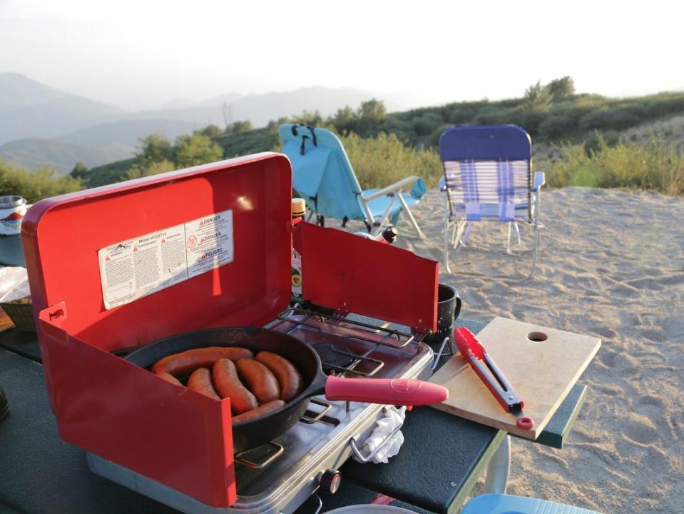 A grill at a campsite cooking dinner.