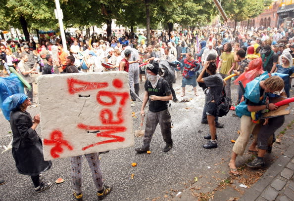 Participants fight in the the annual Vegetable Battle (Gemueseschlacht) on the Oberbaumbruecke on September 2, 2012 in Berlin, Germany. The event pits Kreuzberg district residents againts those of Friedrichshain for control of the Oberbaumbruecke (Oberbaum Bridge), and the two sides pelt each other with rotten vegetables, pet food, ketchup, chicken drumsticks, flour, water guns and styrofoam bats until one side has pushed the other from the bridge. Friedrichshain won the war, in revenge for Kreuzberg's victory the previous year. (Photo by Adam Berry/Getty Images)