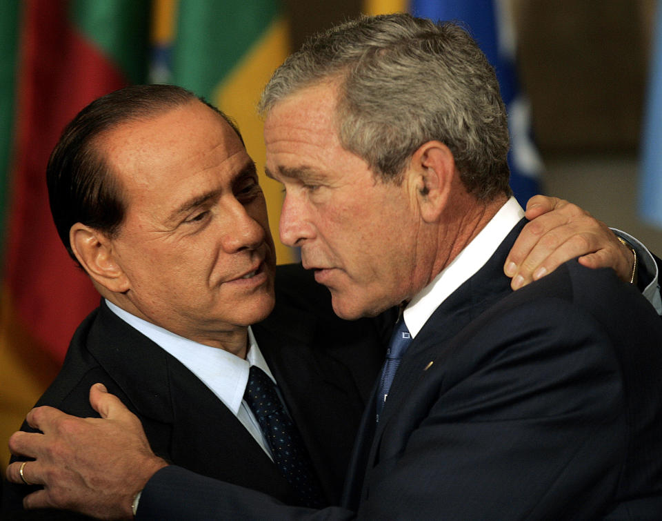 FILE - In this Sept. 14, 2005 file photo, Italian Prime Minister Silvio Berlusconi, left, and U.S. President Bush greet each other prior to a luncheon at the 2005 World Summit at the United Nations headquarters in New York. Berlusconi, the boastful billionaire media mogul who was Italy's longest-serving premier despite scandals over his sex-fueled parties and allegations of corruption, died, according to Italian media. He was 86. (AP Photo/Susan Walsh, file)