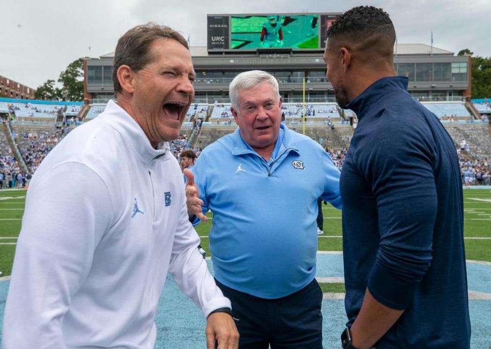 North Carolina defensive coach Gene Chizik laughs as he visits with Notre Dame head coach Marcus Freeman and North Carolina coach Mack Brown prior to their game on Saturday, September 24, 2022 at Kenan Stadium in Chapel Hill, N.C.