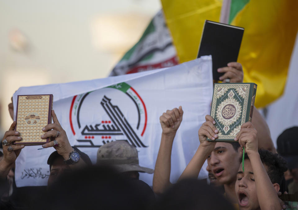 Iraqis raise copies of the Quran, Muslims' holy book, during a protest in Tahrir Square, Thursday، July 20, 2023 in Baghdad, Iraq. The protest was in response to the burning of Quran in Sweden. (AP Photo/Adil AL-Khazali)