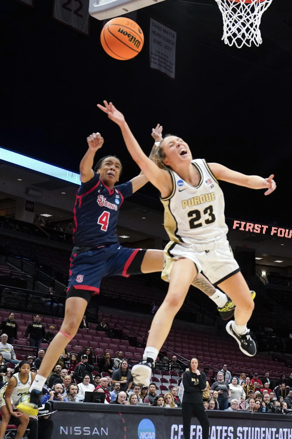 St. John's guard Jayla Everett (4) fouls Purdue guard Abbey Ellis (23) in the second half of a First Four women's college basketball game in the NCAA Tournament Thursday, March 16, 2023, in Columbus, Ohio. (AP Photo/Paul Sancya)