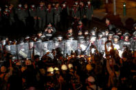 Pro-democracy activists confront a police blockage during their march to the Government House, prime minister's office during a protest march in Bangkok, Thailand, Wednesday, Oct. 21, 2020. Thailand's prime minister on Wednesday pleaded with his countrymen to resolve their political differences through Parliament, as student-led protests seeking to bring his government down continued for an eighth straight day. (AP Photo/Sakchai Lalit)