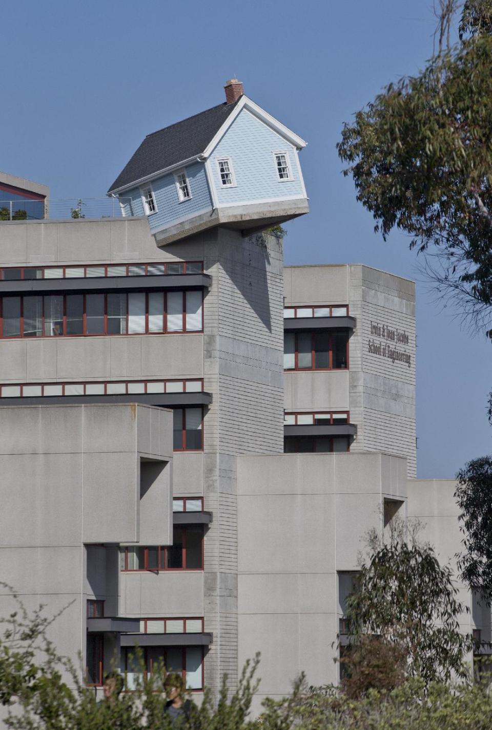 This Oct. 2, 2013 photo shows Fallen Star, a small cottage by artist Do Hi Suh, atop Jacobs Hall, a seven story structure that houses the engineering school on the campus of the University of California-San Diego in San Diego. The piece of art is part of the Stuart Collection, which in a 1982 agreement uses the the entire UCSD campus as a site for commissioned sculpture. The nation’s eighth-largest city has matured from its “Fast Times at Ridgemont High” surf days. Today it boasts a burgeoning international art scene, thriving farm-to-table food movement, and a booming bio-tech industry. (AP Photo/Lenny Ignelzi)