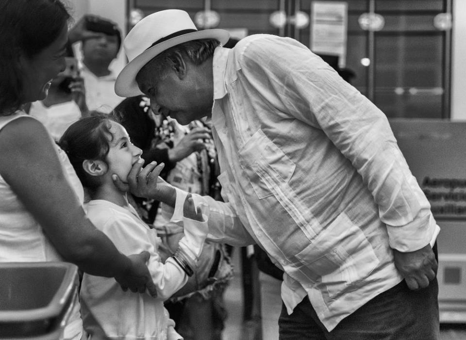 López Obrador greets a young girl in a departures lounge at the airport in Campeche, following a campaign rally, on June 26. He made three final stops on the Yucatán Peninsula before heading back to Mexico City.