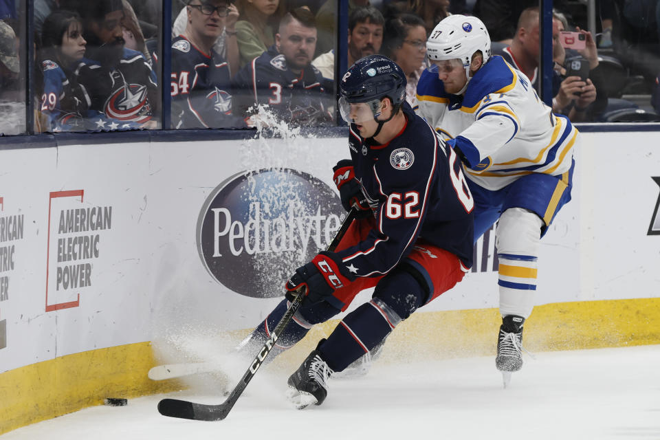 Columbus Blue Jackets' Samuel Knazko, left, and Buffalo Sabres' Casey Mittelstadt chase the puck during the first period of an NHL hockey game Friday, April 14, 2023, in Columbus, Ohio. (AP Photo/Jay LaPrete)