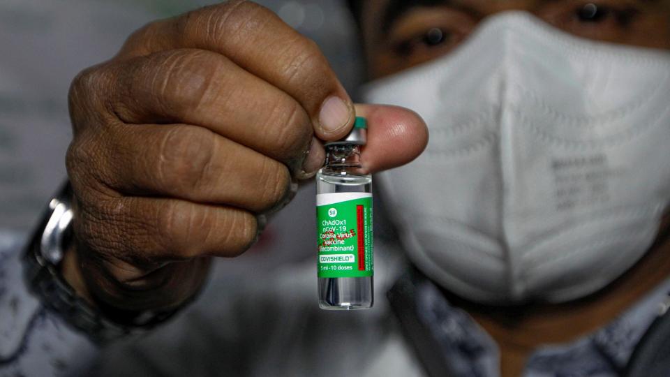 A health worker shows the Covishield vaccine, after arrival of the first batch of the vaccines from the Serum Institute of India at the Civil Hospital, in Ahmedabad, Tuesday, 12 January, 2021.