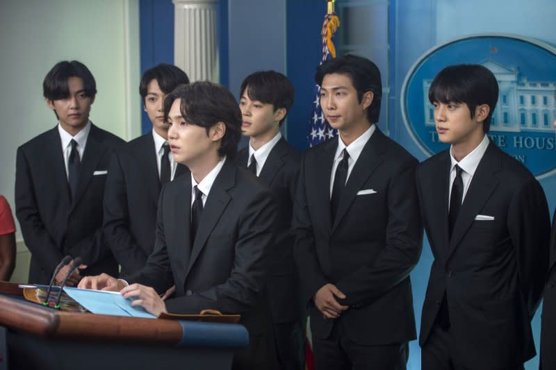 Members of BTS join Karine Jean-Pierre during her daily press briefing at the White House in Washington in 2022. At the podium is Suga, in the rear, from left to right, are V, Jung-kook, Ji-min, RM and Jin.Photo by Bonnie Cash/UPI