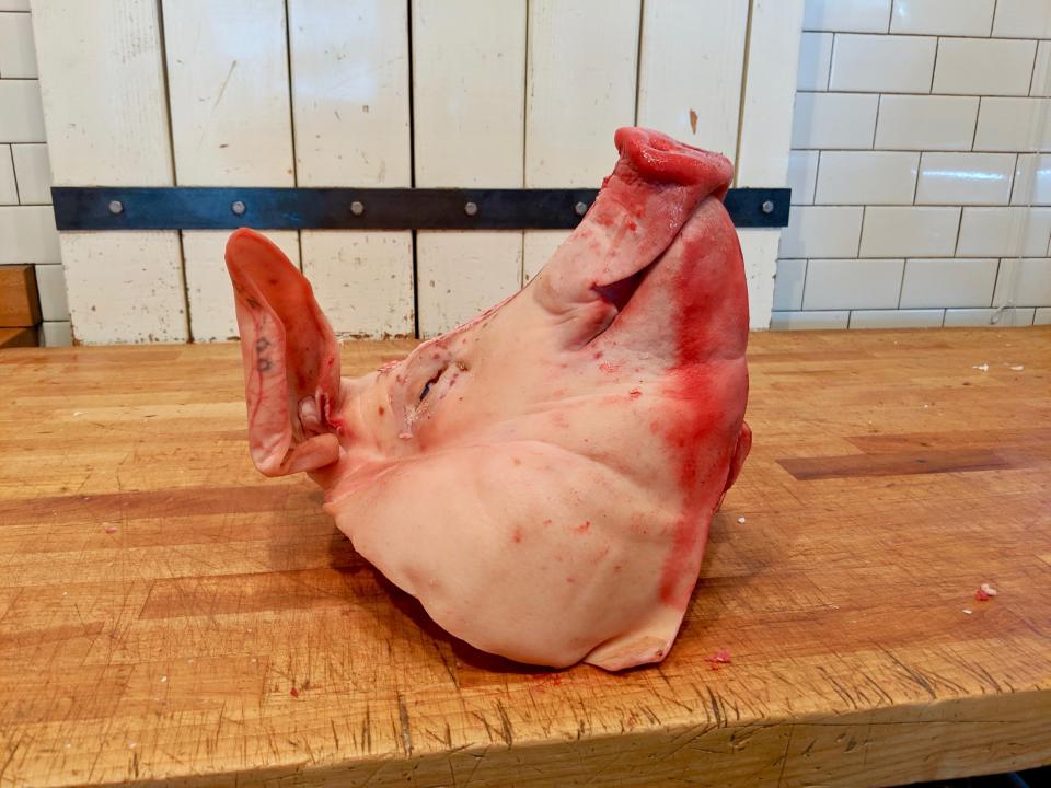 A pig's head sits on the butcher block before being turned into head cheese at Western Daughters in Denver. (Photo: Lee Breslouer/For HuffPost)