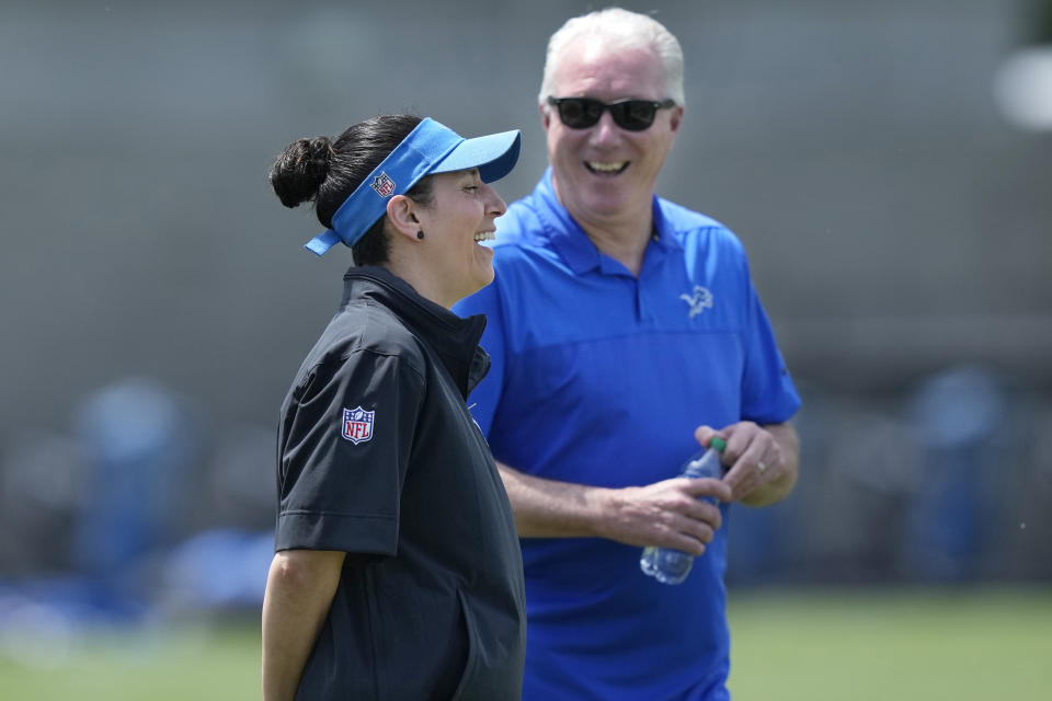 Detroit Lions Director of Sports Medicine Jill Costanza laughs during a conversation with team president Rod Wood during an NFL football practice, Tuesday, June 4, 2024, in Allen Park, Mich. Costanza’s interest in studying ACL injuries and passion for learning new ways to improve performance led the former high school basketball coach and PE teacher on a journey from college sports to the Army to the Air Force to the NFL. Now, she’s an asset for a team with Super Bowl aspirations. (AP Photo/Carlos Osorio)