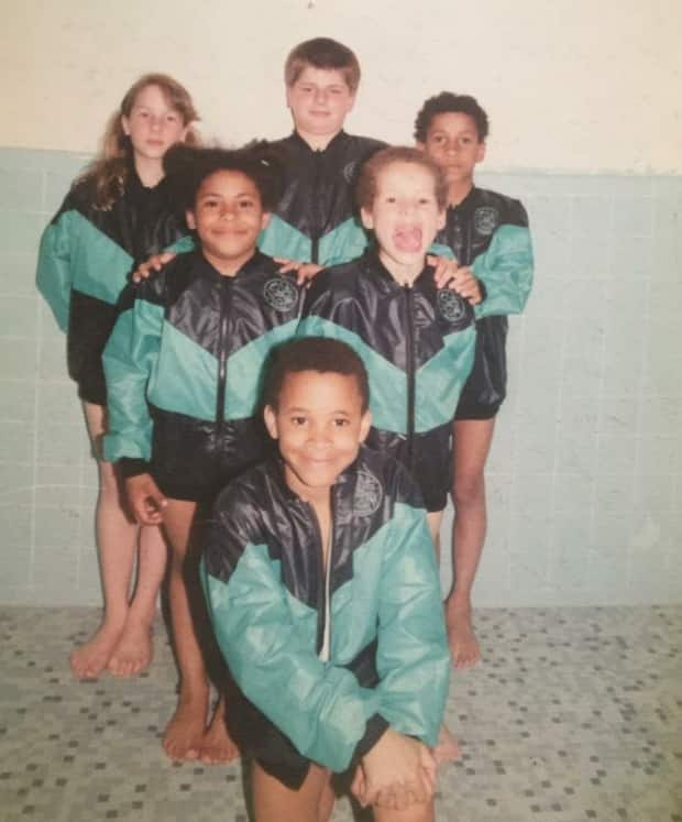 Krystina Alogbo, middle left, appears with her childhood swim team, made up of siblings and cousins. 