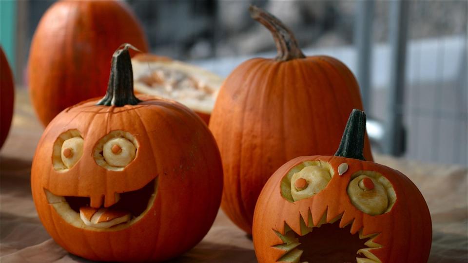 pumpkins decorated with faces with eyes and mouths