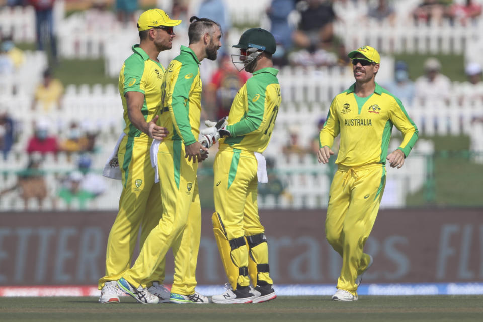 Australia's Glenn Maxwell, second left, is congratulated by teammates after dismissing South Africa's Temba Bavuma during the Cricket Twenty20 World Cup match between South Africa and Australia in Abu Dhabi, UAE, Saturday, Oct. 23, 2021. (AP Photo/Kamran Jebreili )