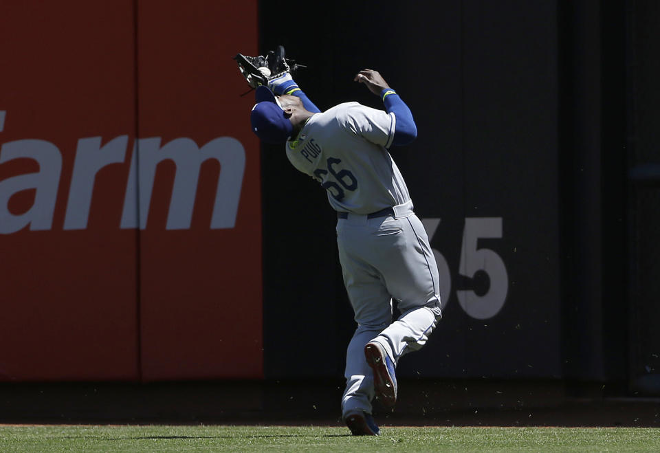 Los Angeles Dodgers right fielder Yasiel Puig catches a fly ball hit by San Francisco Giants' Gregor Blanco during the second inning of a baseball game in San Francisco, Thursday, April 17, 2014. (AP Photo/Jeff Chiu)